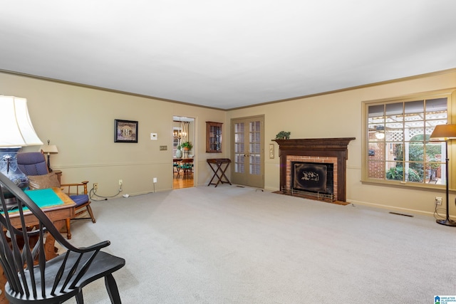 living area with a brick fireplace, ornamental molding, light colored carpet, and french doors