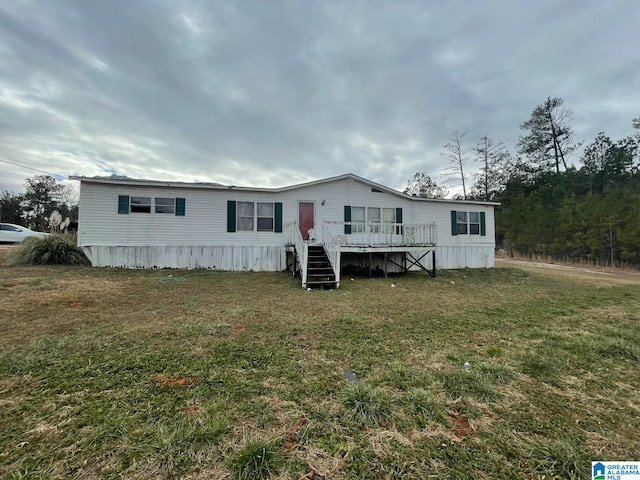 rear view of house featuring a lawn