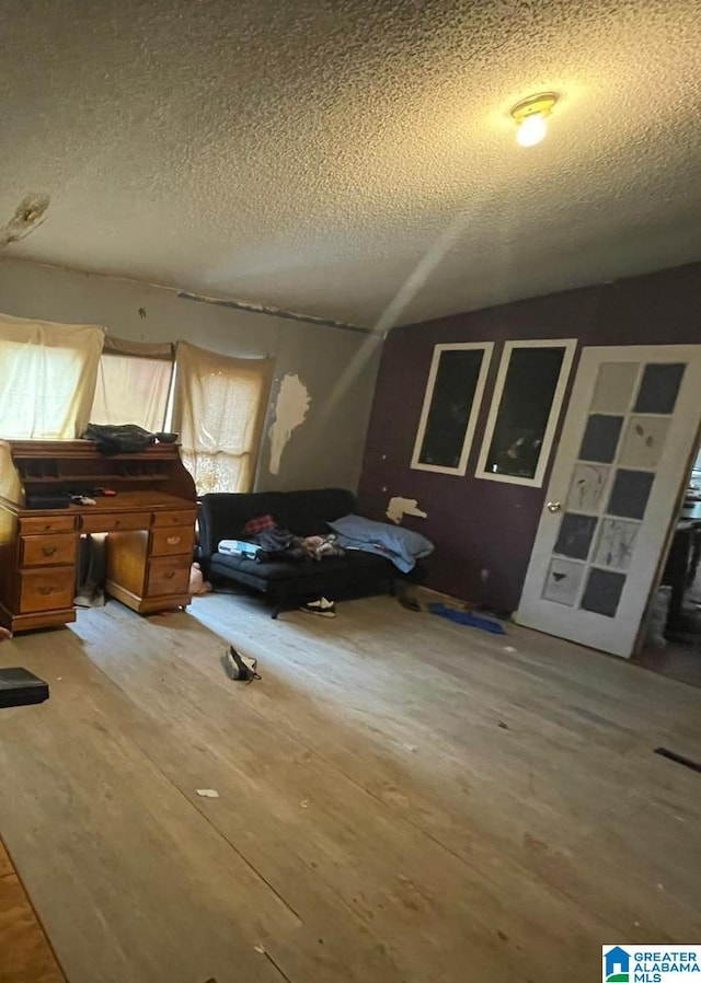 bedroom with hardwood / wood-style flooring and a textured ceiling