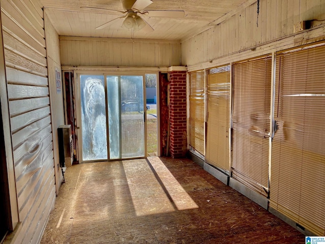 unfurnished sunroom featuring ceiling fan