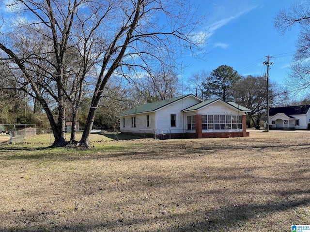 view of side of property with a lawn