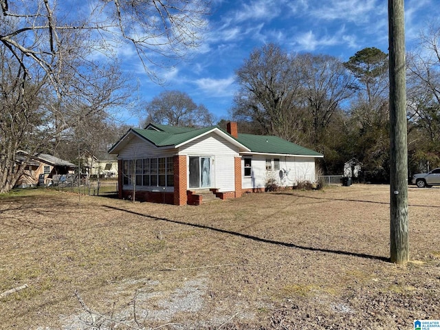 back of house featuring a sunroom