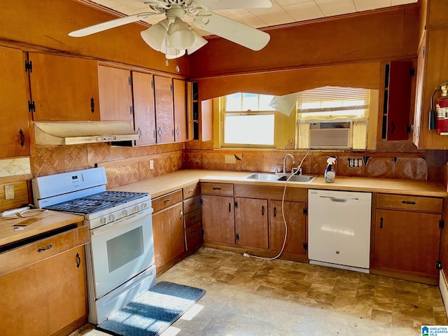 kitchen featuring cooling unit, sink, white appliances, and backsplash