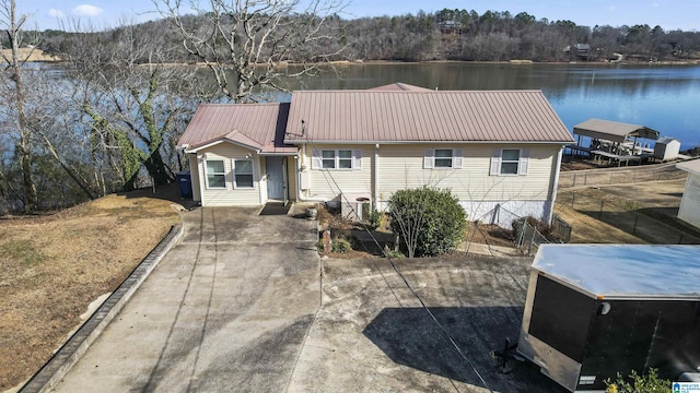 back of property featuring a water view