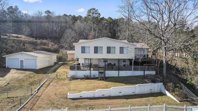 view of front facade featuring a garage, an outdoor structure, a porch, and a front lawn