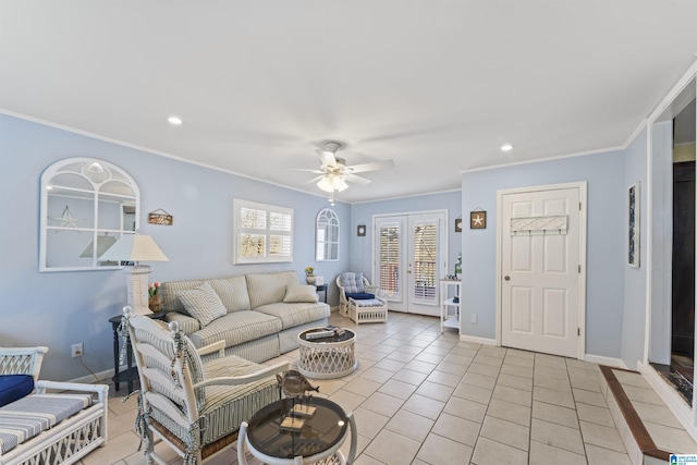 tiled living room with crown molding, ceiling fan, and french doors