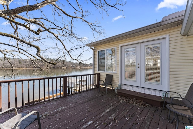 wooden deck featuring french doors and a water view