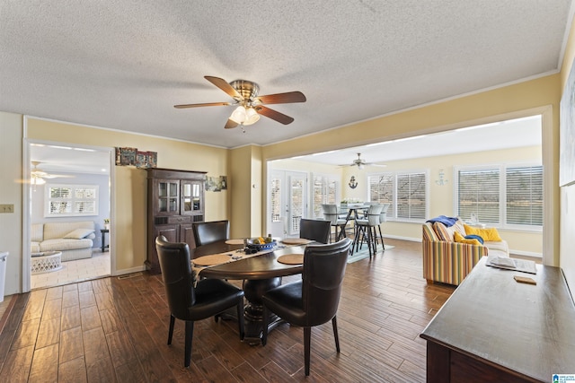 dining area with dark hardwood / wood-style floors, a textured ceiling, and french doors