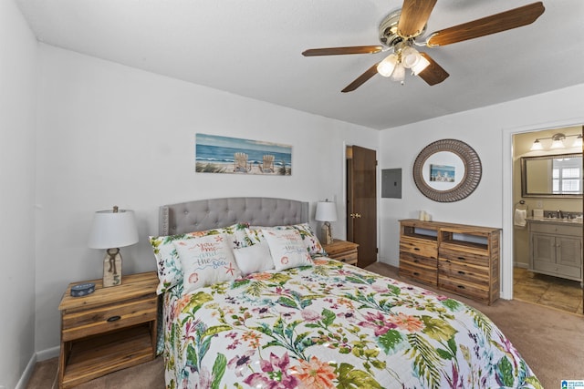 bedroom featuring sink, ensuite bath, carpet flooring, electric panel, and ceiling fan