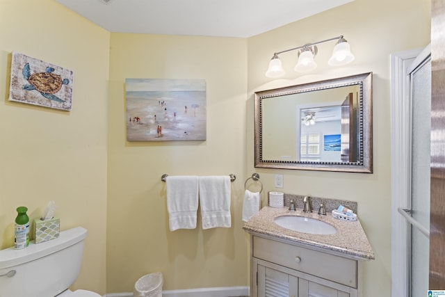 bathroom featuring vanity and toilet