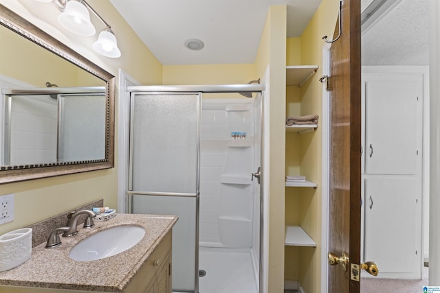 bathroom with vanity and a shower with shower door