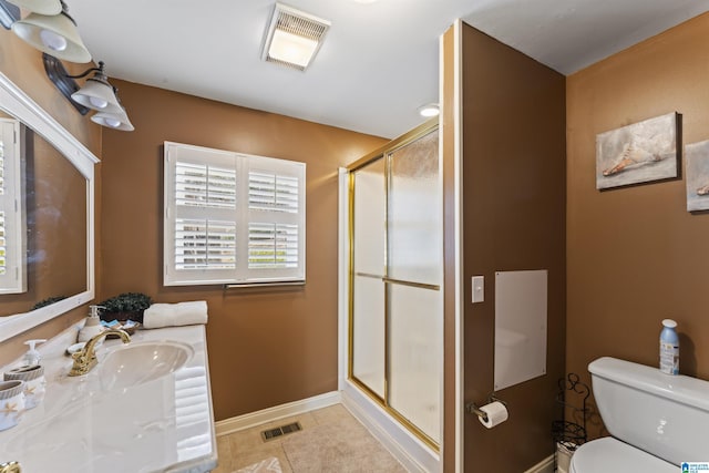 bathroom featuring tile patterned flooring, toilet, sink, and walk in shower