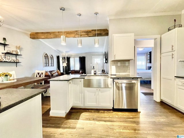 kitchen featuring white cabinetry, sink, hanging light fixtures, stainless steel dishwasher, and light wood-type flooring