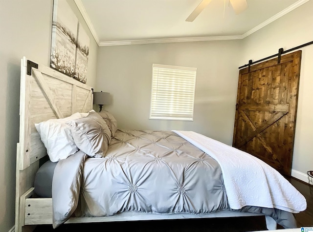 bedroom with crown molding, ceiling fan, and a barn door