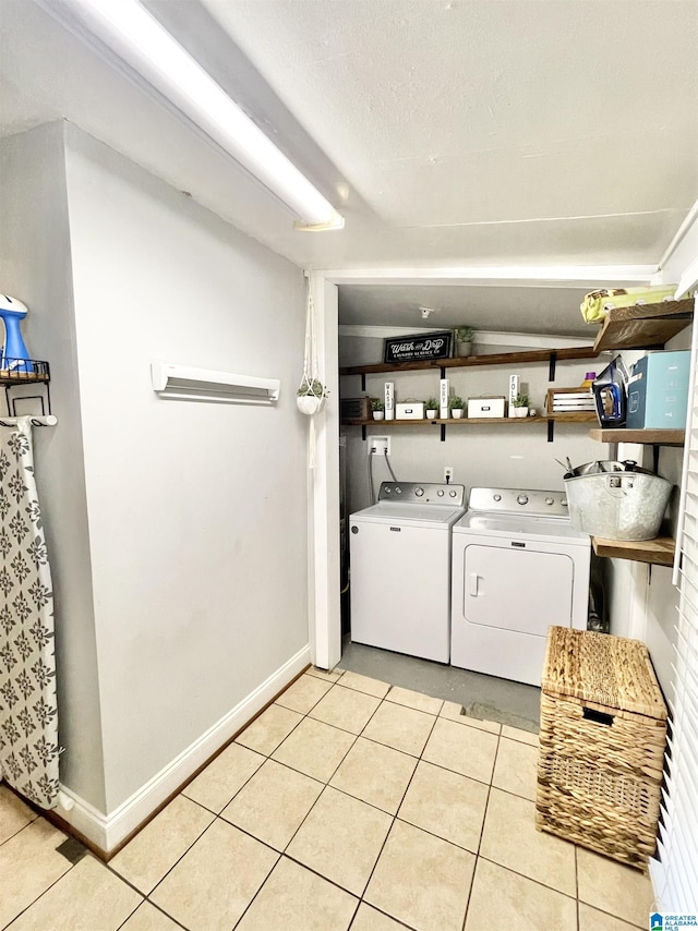 laundry area with washing machine and dryer and light tile patterned floors