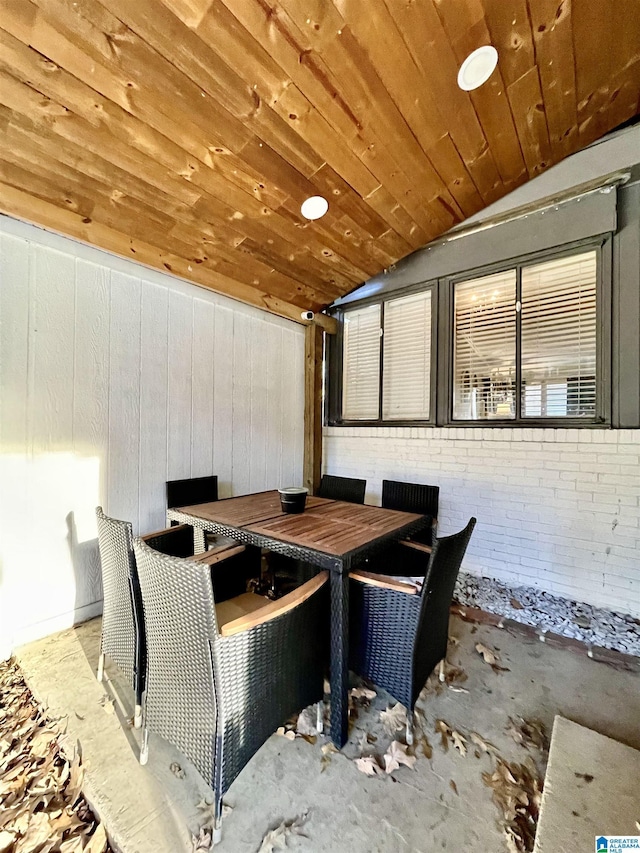 dining area featuring wood ceiling and vaulted ceiling