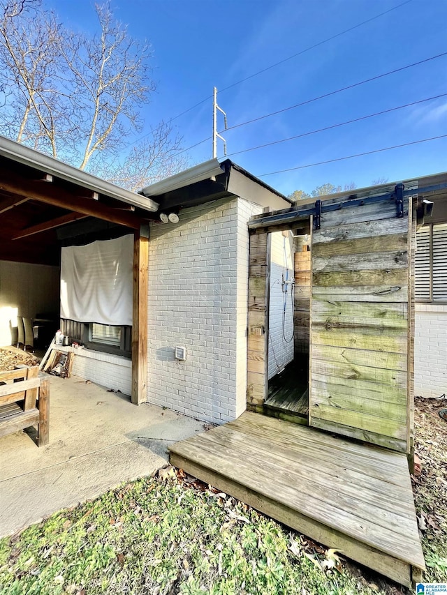 view of side of property with a wooden deck