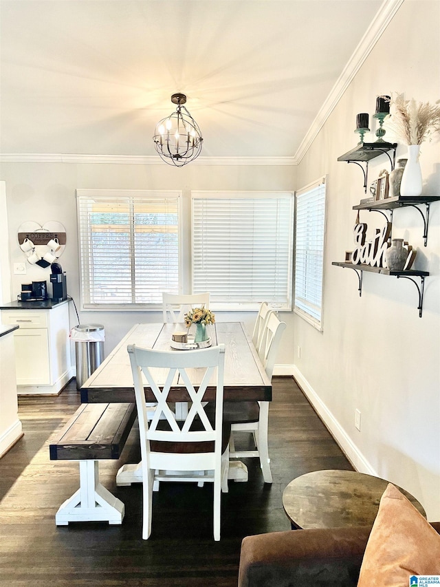 dining area featuring crown molding, dark wood-type flooring, a wealth of natural light, and a notable chandelier