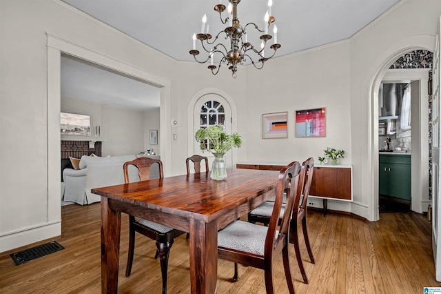 dining room featuring crown molding and wood-type flooring