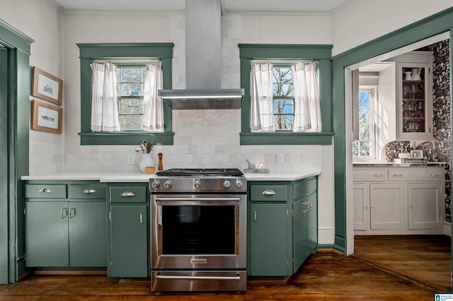 kitchen featuring dark wood-type flooring, backsplash, stainless steel gas range, and wall chimney range hood