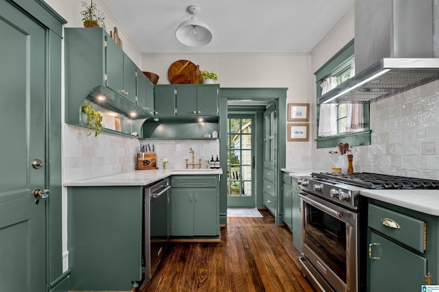 kitchen with green cabinetry, appliances with stainless steel finishes, ventilation hood, and sink