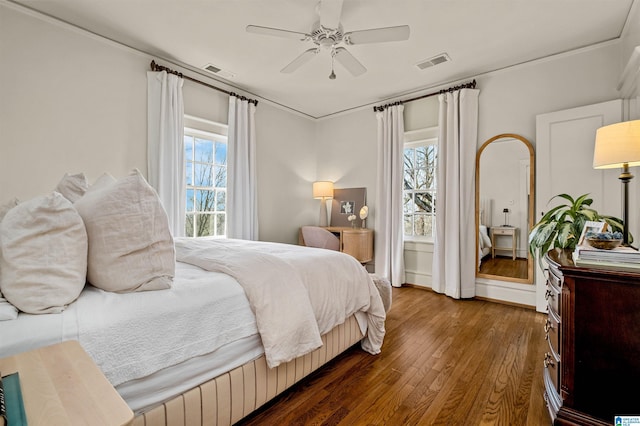 bedroom with dark wood-type flooring and ceiling fan