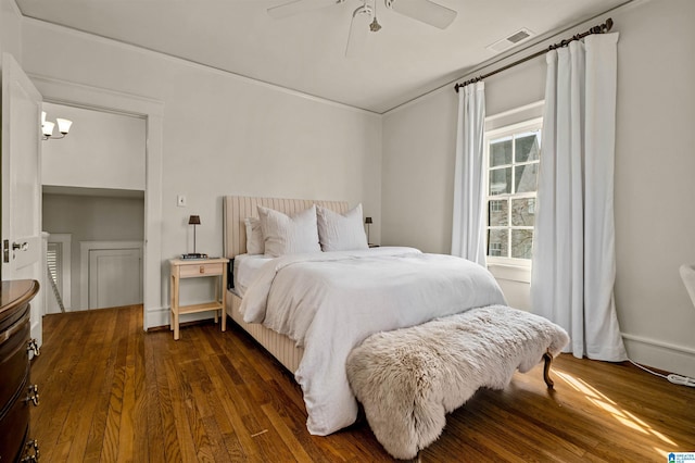 bedroom with dark wood-type flooring and ceiling fan