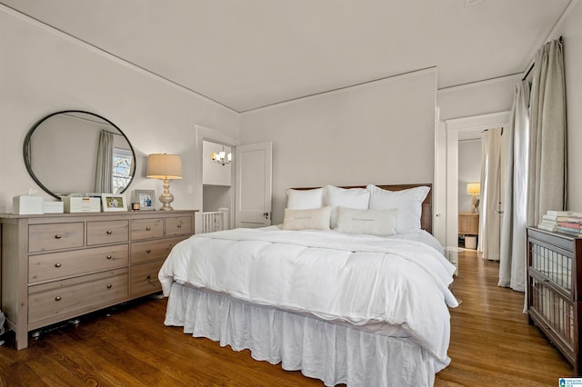 bedroom with dark hardwood / wood-style flooring