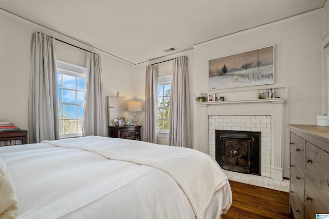 bedroom featuring a fireplace and dark wood-type flooring