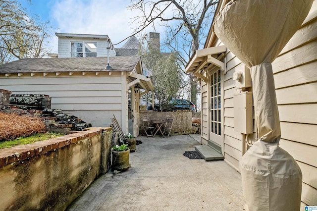 view of side of property with a patio area