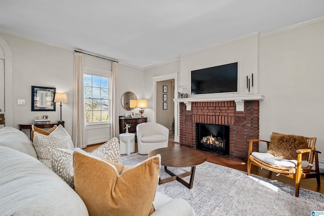 living room with hardwood / wood-style floors, a fireplace, and ornamental molding