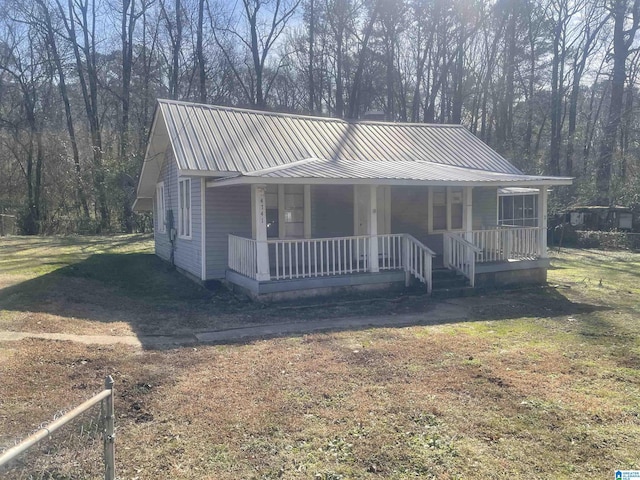 view of front of property with covered porch and a front lawn