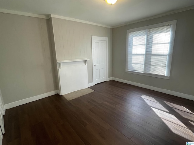 interior space with baseboards, dark wood finished floors, and crown molding