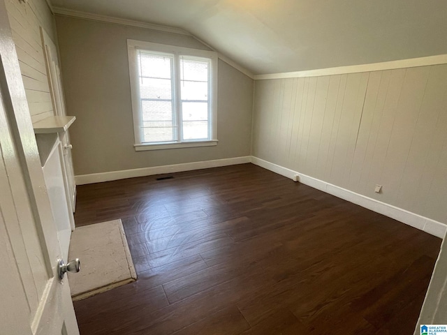 bonus room featuring dark wood-style floors, lofted ceiling, and baseboards