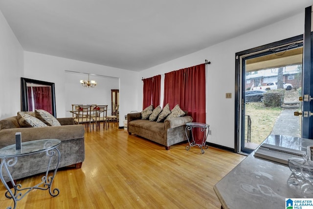 living room with hardwood / wood-style flooring, a chandelier, and a wealth of natural light