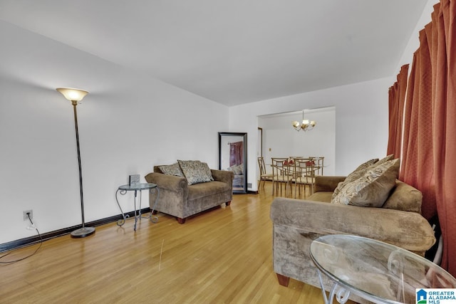 living room with a chandelier and light hardwood / wood-style flooring