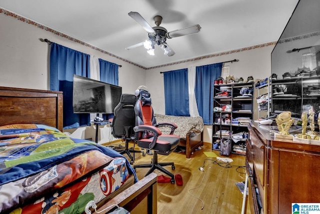 bedroom with ceiling fan and light hardwood / wood-style floors