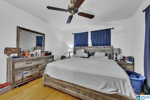 bedroom with hardwood / wood-style floors and ceiling fan