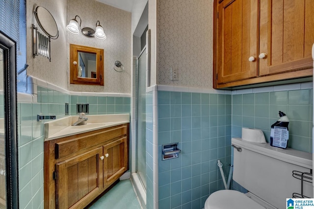 bathroom with tile walls, vanity, a shower, and toilet