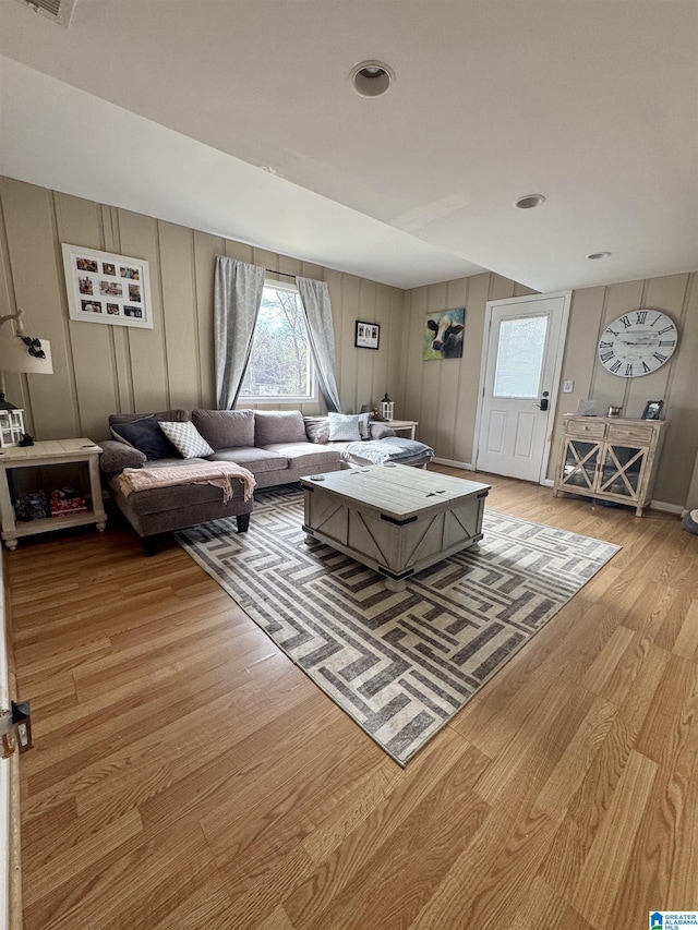 living room with a wealth of natural light and light hardwood / wood-style flooring