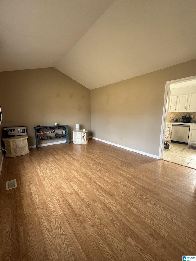 interior space featuring lofted ceiling and light wood-type flooring