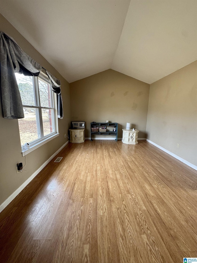 bonus room featuring vaulted ceiling and light hardwood / wood-style floors