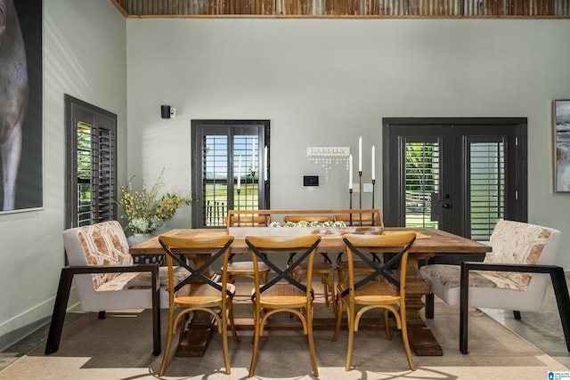 dining room with french doors, breakfast area, and a high ceiling