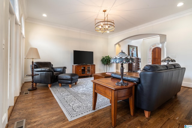 living room with crown molding, a notable chandelier, and dark hardwood / wood-style flooring