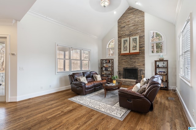 living room with a stone fireplace, ornamental molding, high vaulted ceiling, and dark hardwood / wood-style floors