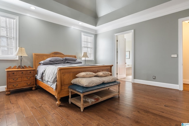 bedroom featuring crown molding, connected bathroom, and hardwood / wood-style floors