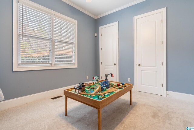 recreation room featuring ornamental molding and light colored carpet