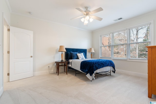 carpeted bedroom featuring crown molding and ceiling fan