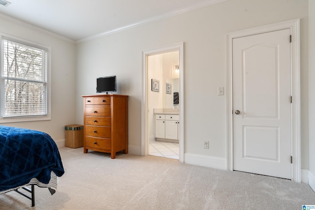 bedroom with light carpet, crown molding, and ensuite bathroom