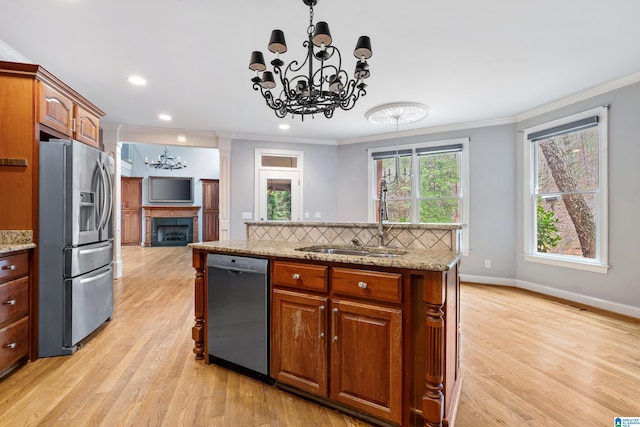 kitchen with sink, decorative light fixtures, decorative backsplash, and appliances with stainless steel finishes